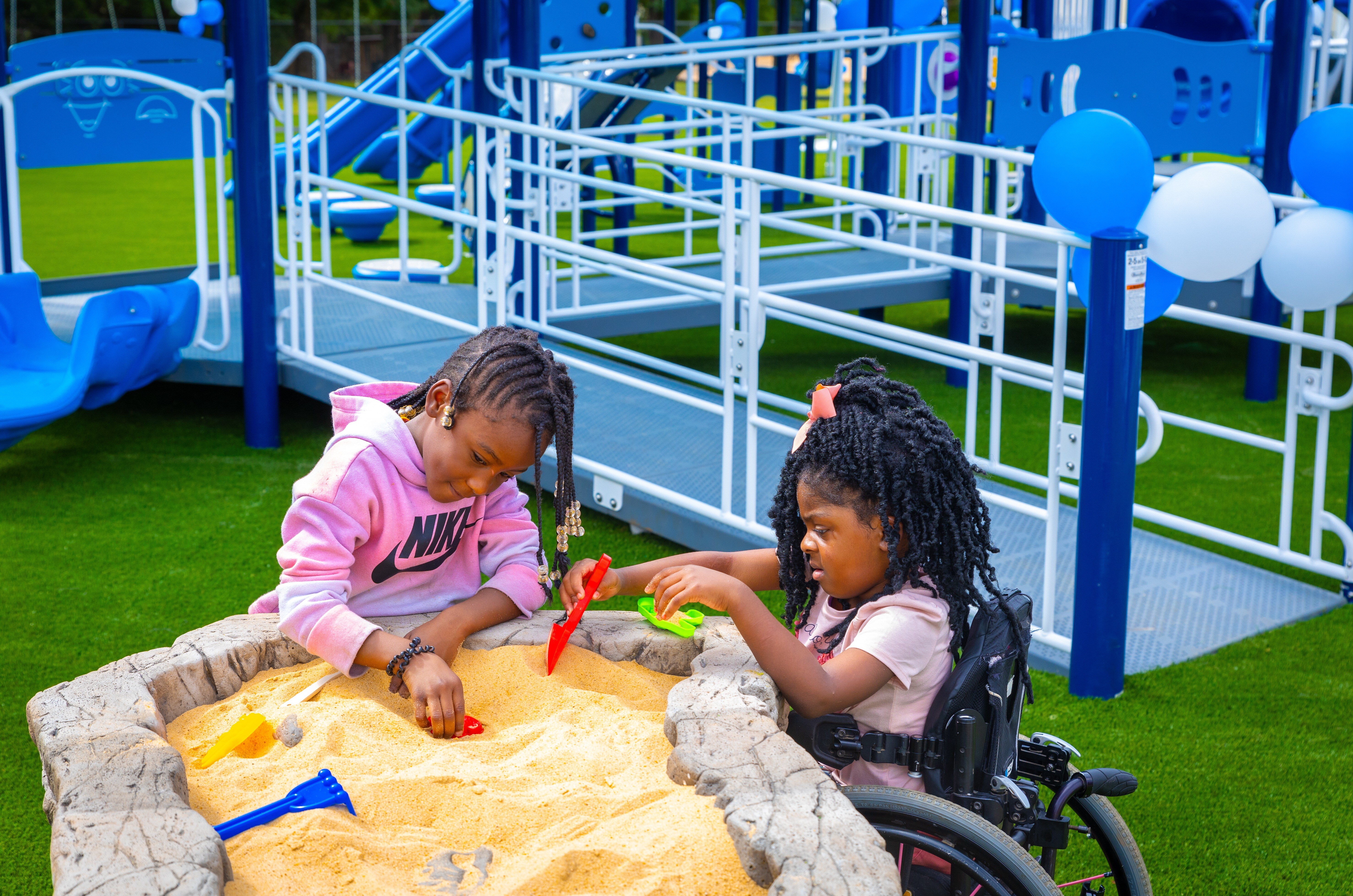 Girls playing in sand pit at MS Healthy Schools